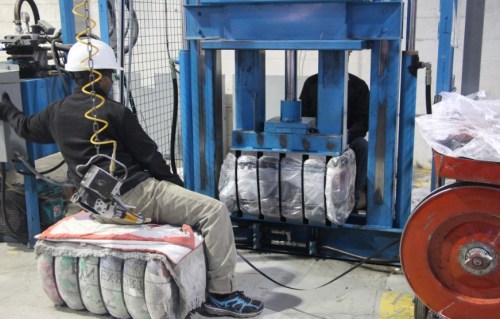 Workers at DYN Exports create the clothing bails.