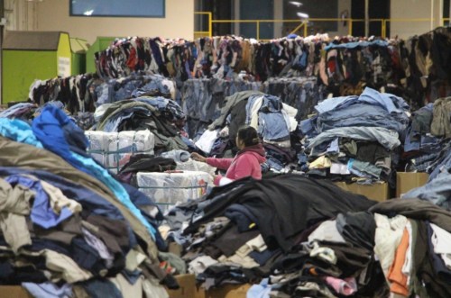 An employee sorts clothing at DYN Exports