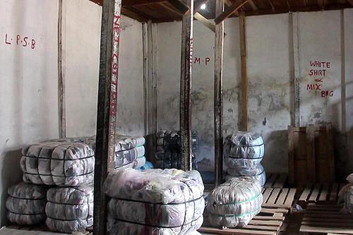 Clothing bails await buyers at a Freetown wholesaler.